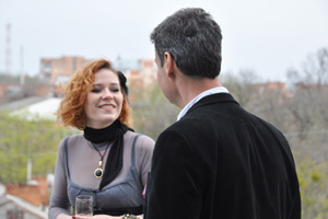 A photo of a Woman and Man Talking on the balcony