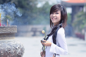 A photo of a Thai lady burning incense